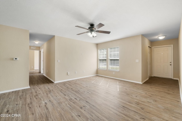 empty room featuring light hardwood / wood-style floors and ceiling fan