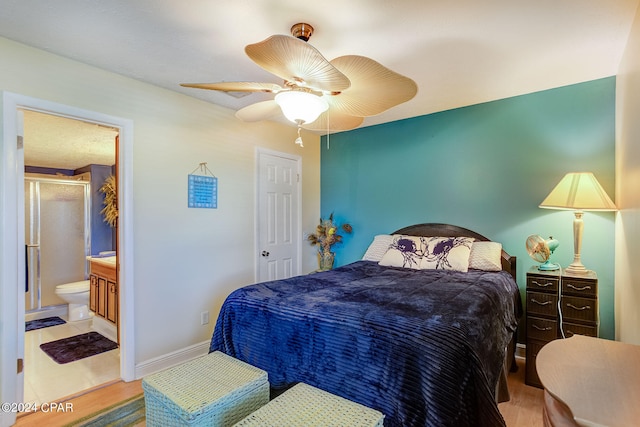 bedroom featuring ceiling fan, ensuite bathroom, and light tile flooring