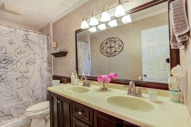 bathroom featuring ornamental molding, a textured ceiling, double vanity, and toilet