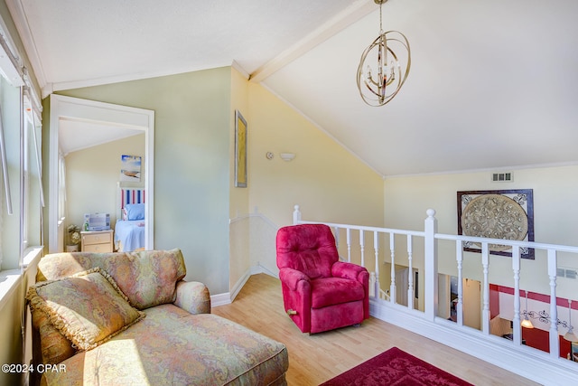 living room featuring a notable chandelier, light hardwood / wood-style floors, and vaulted ceiling