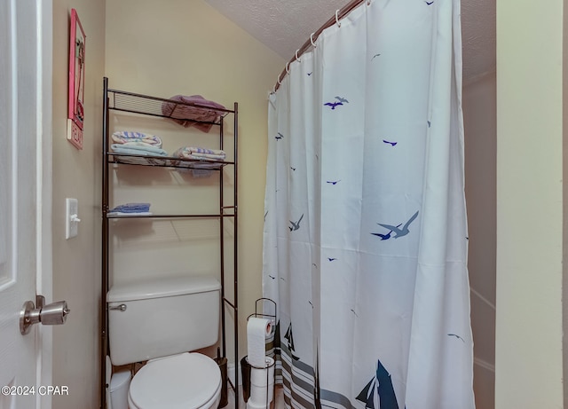 bathroom featuring a textured ceiling and toilet