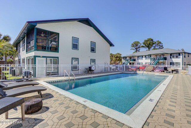 view of swimming pool with a patio