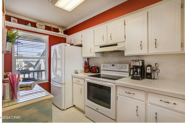 kitchen featuring tasteful backsplash, white appliances, tile countertops, light tile floors, and white cabinets