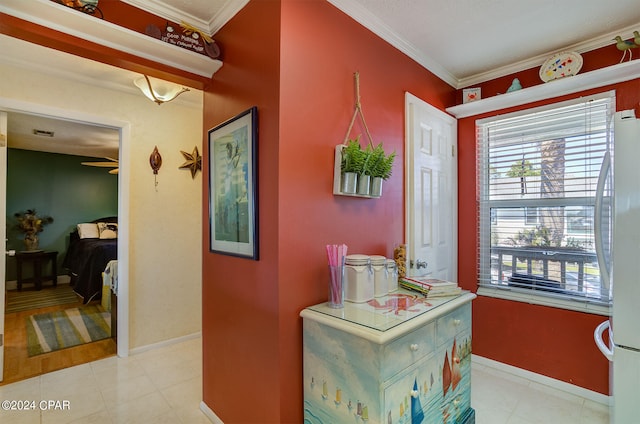 hall featuring ornamental molding and light tile floors