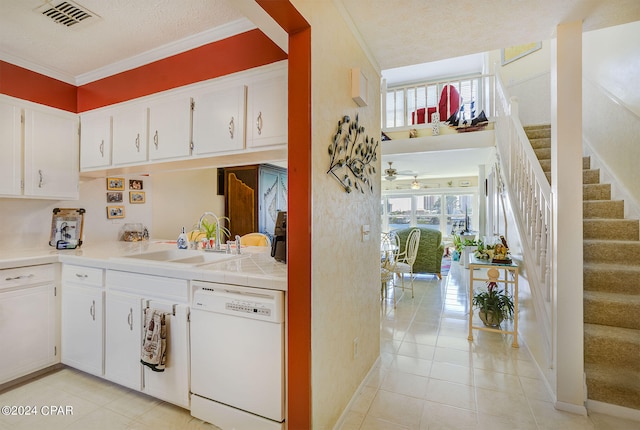 kitchen featuring plenty of natural light, white cabinetry, sink, and white dishwasher