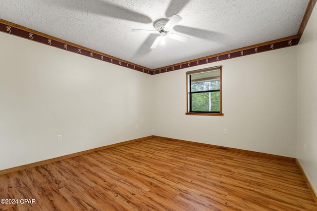 spare room with hardwood / wood-style flooring, ceiling fan, and a textured ceiling