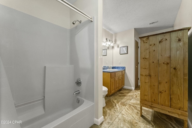 full bathroom featuring toilet, a textured ceiling, vanity, shower / tub combination, and tile floors