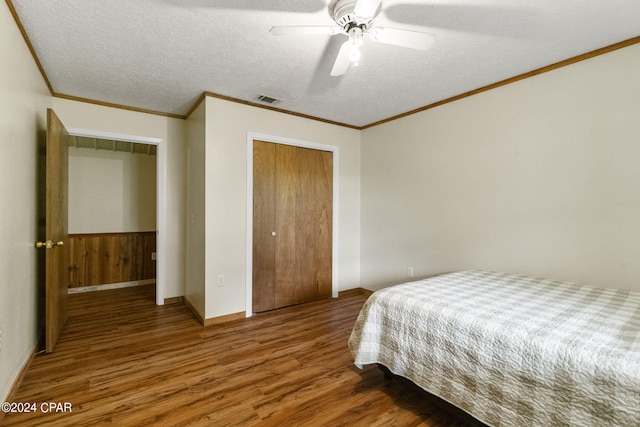 bedroom featuring wood-type flooring, ceiling fan, and a textured ceiling