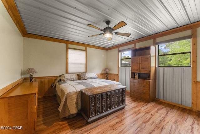 bedroom featuring wood ceiling, light hardwood / wood-style flooring, ceiling fan, and ornamental molding