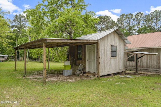 view of shed / structure featuring a yard and a carport