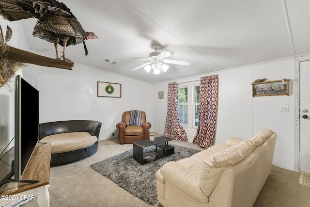 carpeted living room with ceiling fan, a textured ceiling, and lofted ceiling