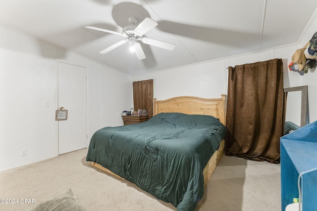 carpeted bedroom featuring vaulted ceiling, ceiling fan, and a textured ceiling