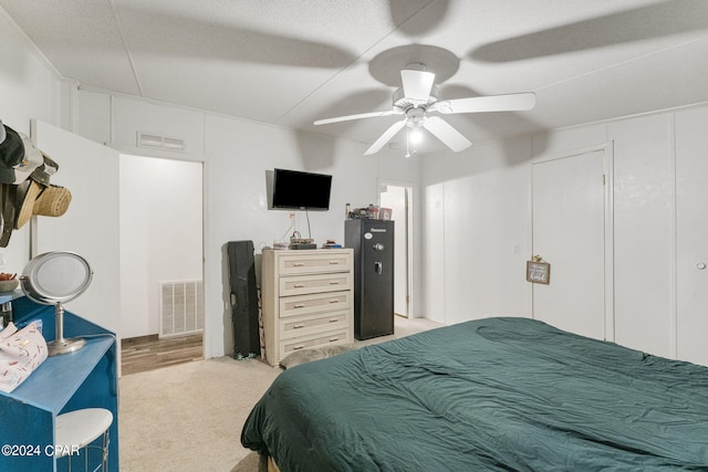 bedroom with light colored carpet and ceiling fan