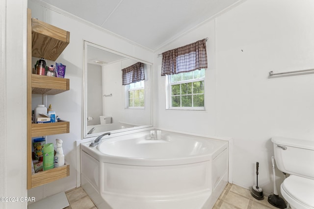 bathroom with tile floors, toilet, a bathing tub, and lofted ceiling