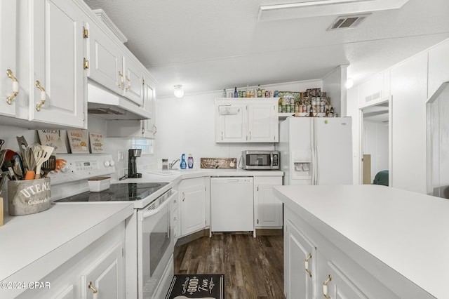 kitchen featuring white cabinetry, dark wood-type flooring, white appliances, and vaulted ceiling