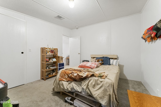 bedroom with a textured ceiling and carpet flooring