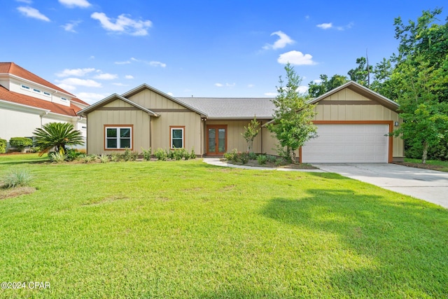 ranch-style house featuring a garage and a front yard