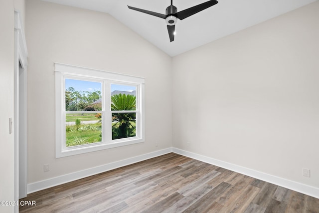 empty room featuring vaulted ceiling, hardwood / wood-style floors, and ceiling fan