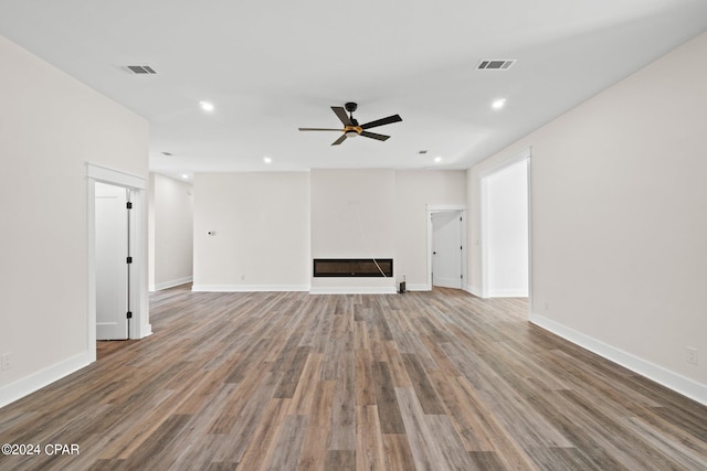 unfurnished living room with hardwood / wood-style flooring and ceiling fan