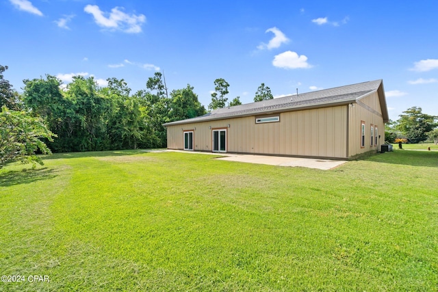 back of house with a patio, central AC, and a lawn