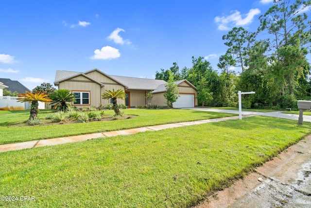 single story home featuring a garage and a front lawn