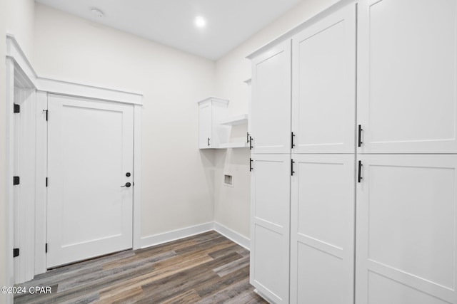 laundry room with washer hookup, dark hardwood / wood-style flooring, and cabinets