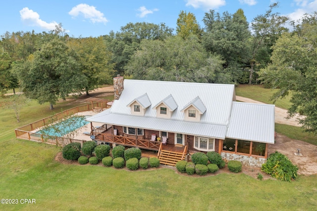 exterior space featuring a deck and a lawn