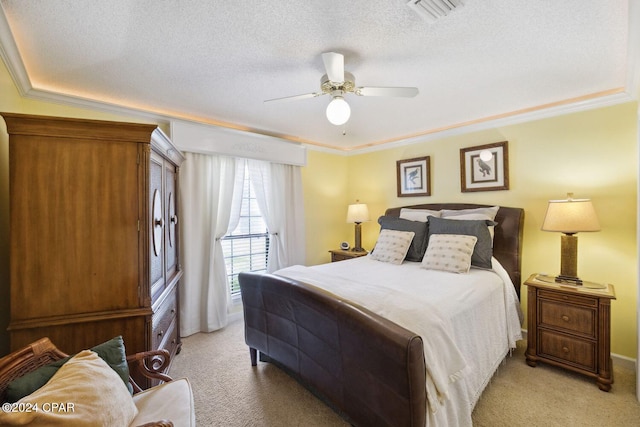 bedroom featuring ornamental molding, light colored carpet, ceiling fan, and a textured ceiling