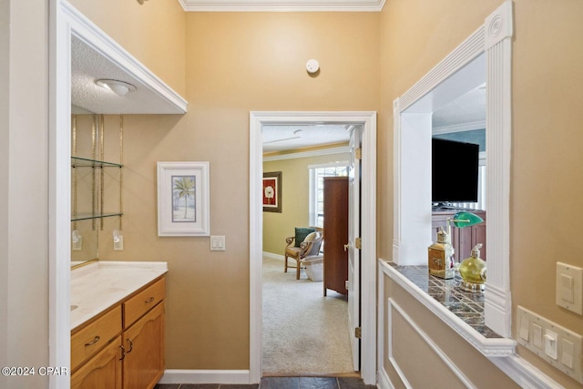 corridor featuring ornamental molding and light carpet