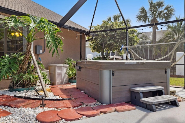 view of side of home featuring a hot tub