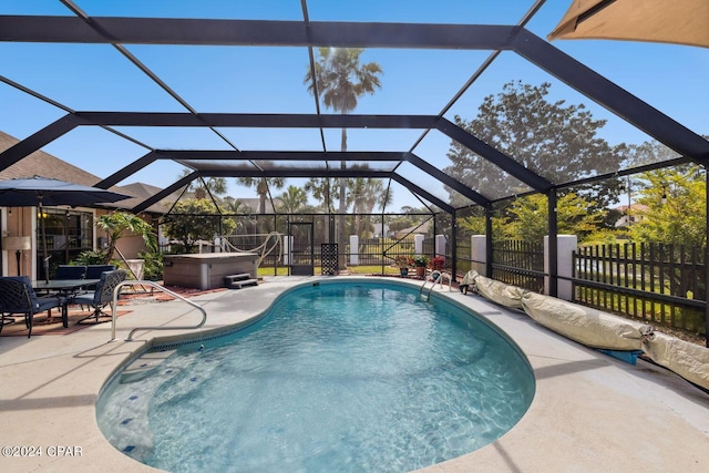 view of swimming pool featuring glass enclosure