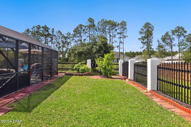 view of yard with glass enclosure