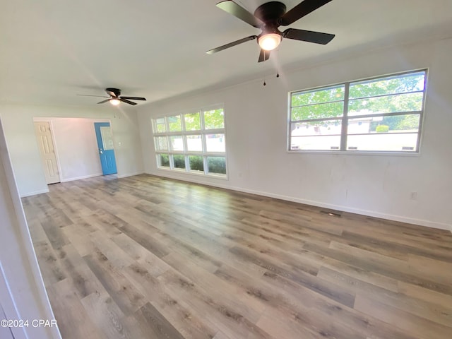 empty room featuring wood-type flooring and ceiling fan