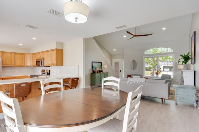 dining space with ceiling fan and light hardwood / wood-style floors