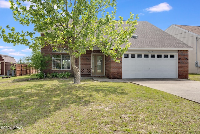 view of front of house with a garage and a front yard