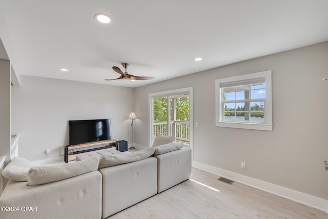 living room with ceiling fan and light hardwood / wood-style floors