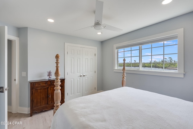 bedroom with light wood-type flooring, a closet, and ceiling fan