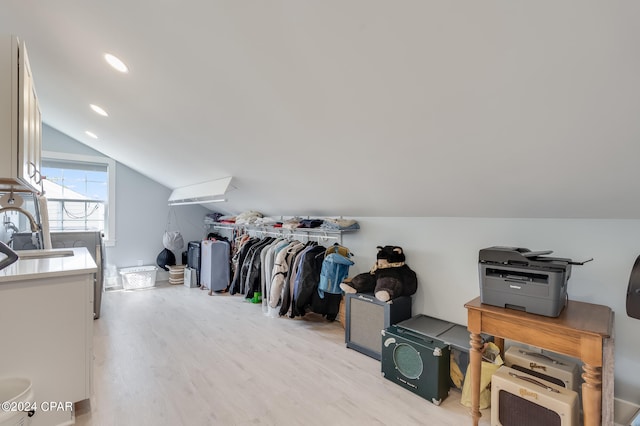 bonus room with lofted ceiling, light hardwood / wood-style flooring, and sink