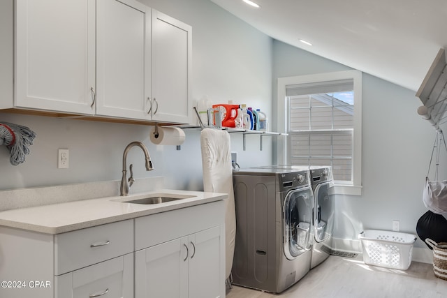 laundry room with cabinets, sink, and washer and clothes dryer