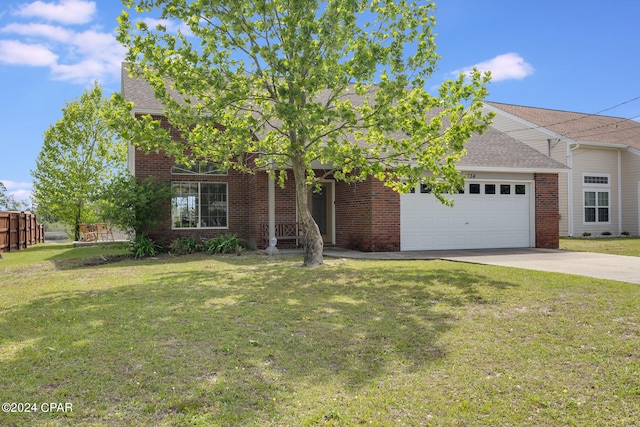 view of front of property with a garage and a front yard