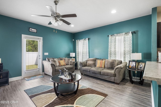 living room with hardwood / wood-style floors and ceiling fan