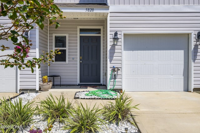 doorway to property with a garage