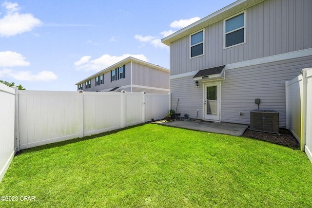 rear view of property featuring central AC, a yard, and a patio