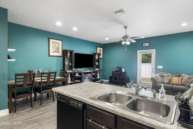 kitchen with light wood-type flooring, sink, dishwasher, ceiling fan, and a textured ceiling