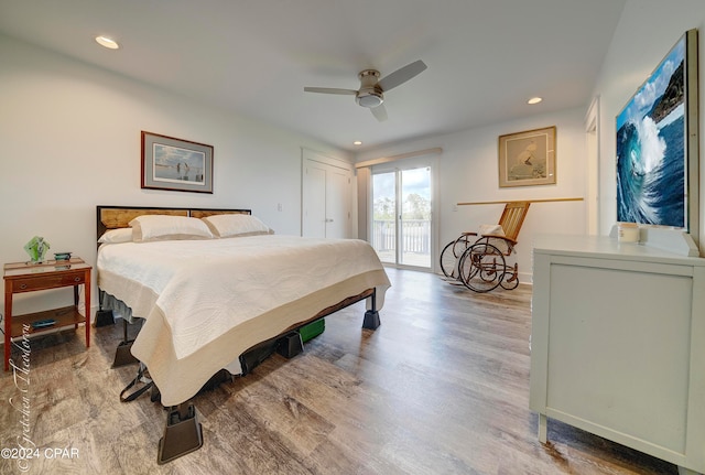 bedroom featuring hardwood / wood-style floors, ceiling fan, and access to exterior