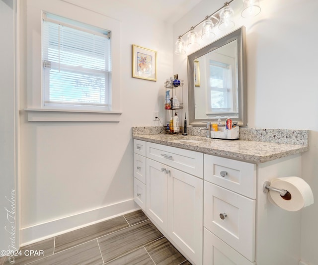 bathroom featuring a wealth of natural light, vanity, and tile floors