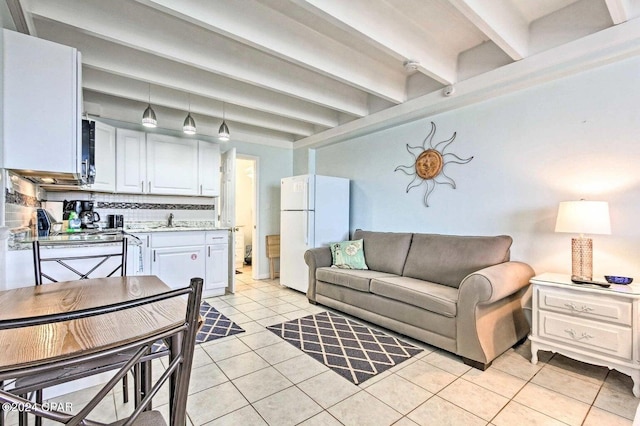 tiled living room featuring beam ceiling and sink