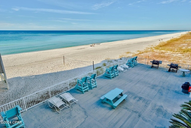 aerial view with a water view and a beach view