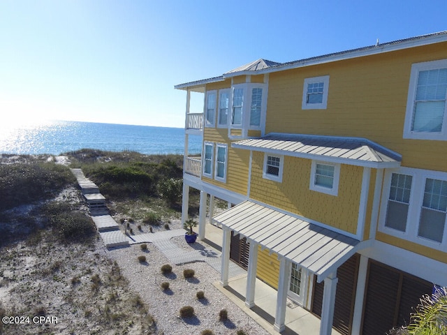 exterior space with a patio and a water view