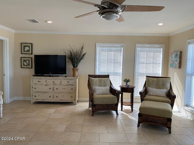 sitting room featuring a healthy amount of sunlight, ceiling fan, light tile floors, and ornamental molding